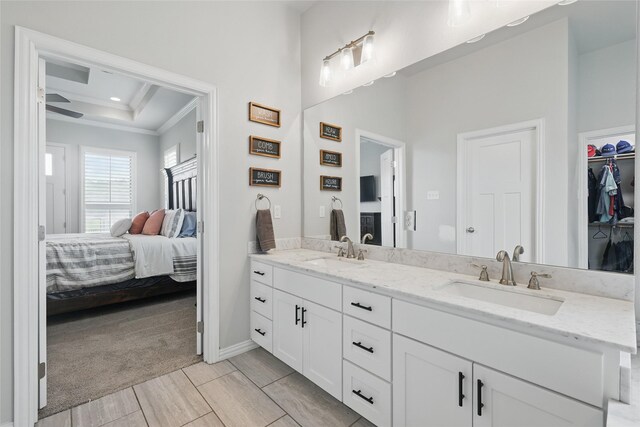 115 Lavender Ln, Springtown, TX 76082 - bathroom with crown molding, ensuite bathroom, double vanity, a tray ceiling, and baseboards