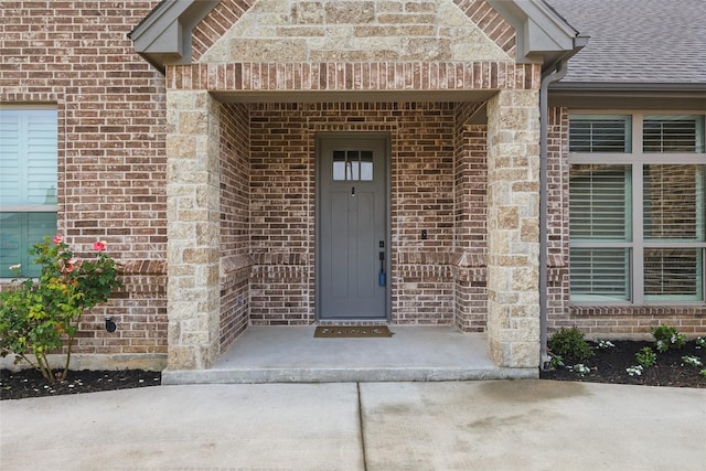 115 Lavender Ln, Springtown, TX 76082 - doorway to property featuring brick siding and roof with shingles