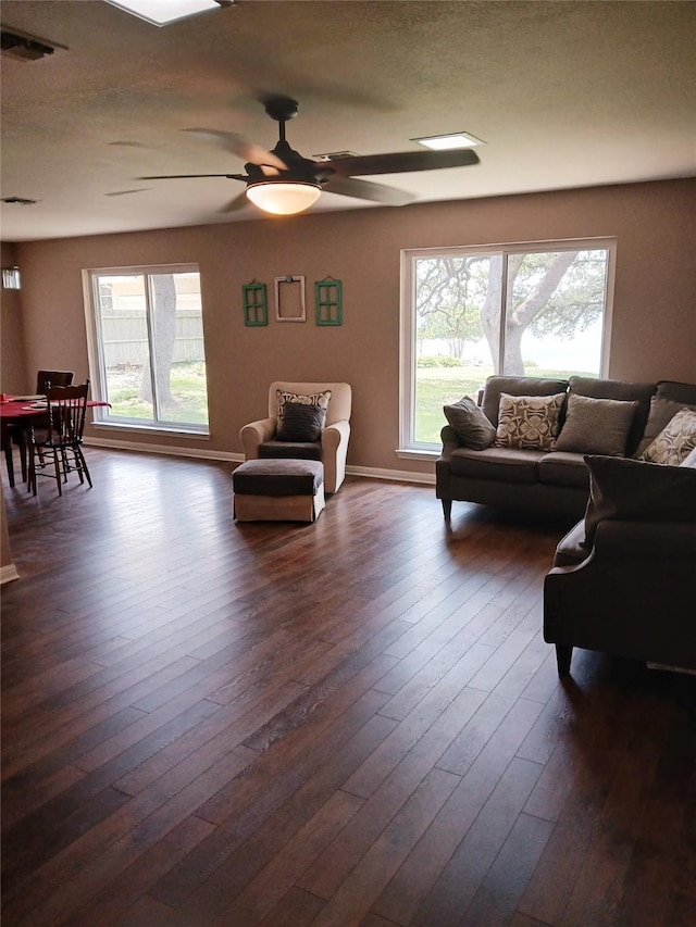 650 Sp Terry Rd, Belton, TX 76513 - living area with a ceiling fan, dark wood-style floors, and baseboards