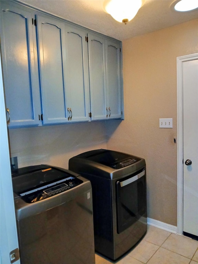 650 Sp Terry Rd, Belton, TX 76513 - laundry room featuring washer and clothes dryer, cabinet space, light tile patterned floors, and baseboards
