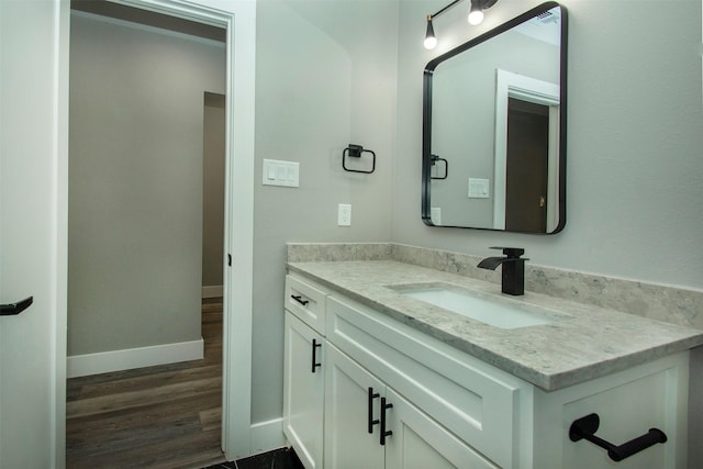 519 W James St, Wills Point, TX 75169 - bathroom featuring vanity, wood finished floors, and baseboards