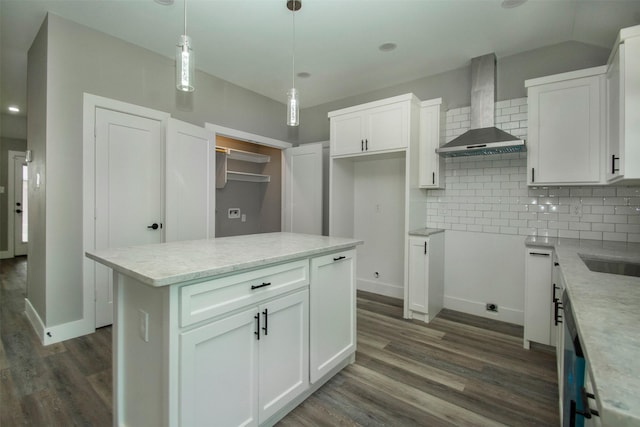519 W James St, Wills Point, TX 75169 - kitchen featuring wall chimney range hood, dark wood-style floors, tasteful backsplash, white cabinetry, and hanging light fixtures