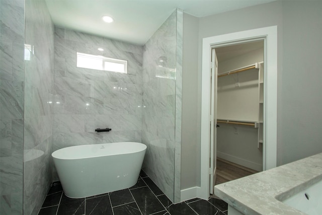 519 W James St, Wills Point, TX 75169 - full bath with a freestanding tub, a walk in closet, and vanity