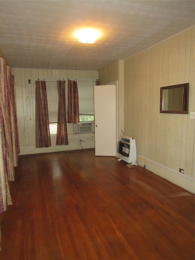 101 E Murray St, Denison, TX 75021 - unfurnished room featuring heating unit, wooden walls, wood finished floors, and cooling unit