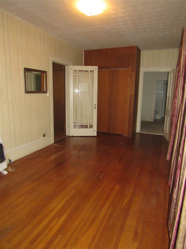 101 E Murray St, Denison, TX 75021 - spare room featuring wood finished floors and wooden walls