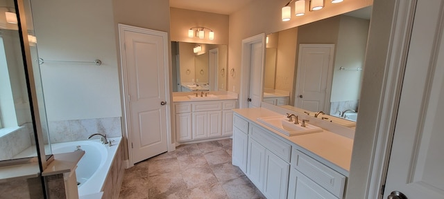 3805 Bentley Dr, Bedford, TX 76021 - bathroom featuring two vanities and a garden tub