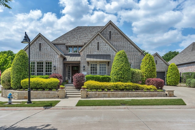 444 Francie Way, Allen, TX 75013 - french country inspired facade with a standing seam roof, brick siding, concrete driveway, metal roof, and a garage