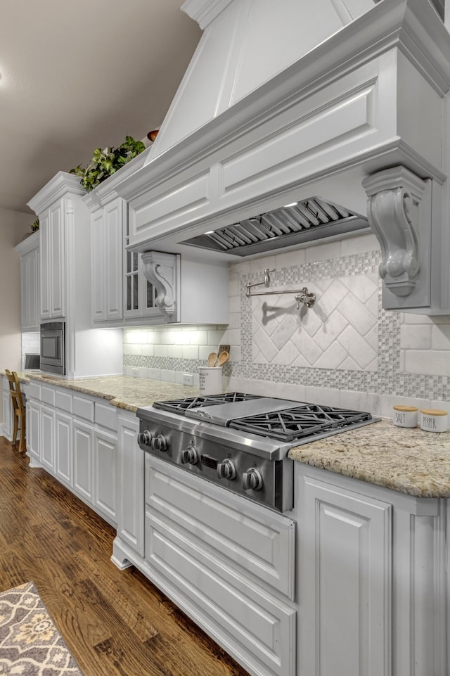 444 Francie Way, Allen, TX 75013 - kitchen with stainless steel appliances, white cabinetry, dark wood-style flooring, tasteful backsplash, and light stone countertops
