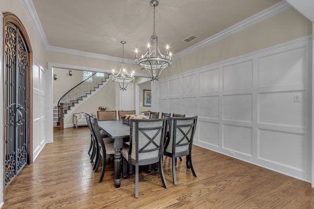 444 Francie Way, Allen, TX 75013 - dining space featuring a decorative wall, a chandelier, stairs, ornamental molding, and wood finished floors