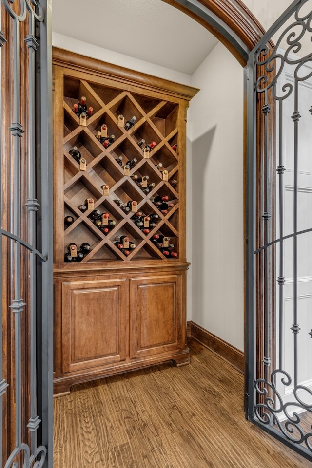 444 Francie Way, Allen, TX 75013 - wine cellar with arched walkways, wood finished floors, and baseboards