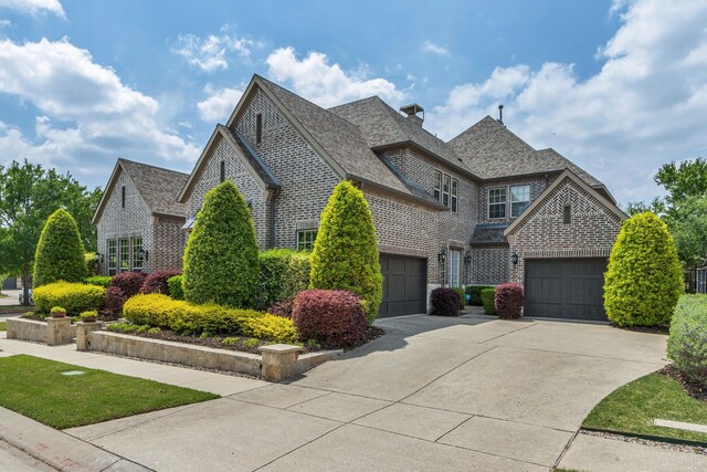 444 Francie Way, Allen, TX 75013 - french country home featuring concrete driveway, brick siding, and a chimney