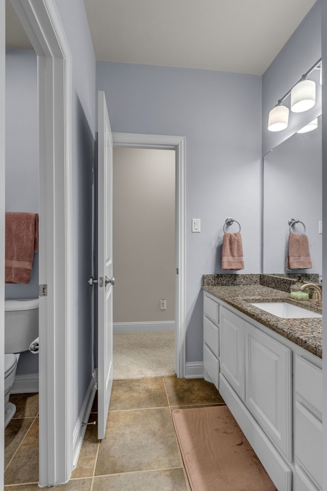 444 Francie Way, Allen, TX 75013 - bathroom with toilet, vanity, baseboards, and tile patterned floors
