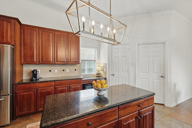 12303 Blue Ridge Dr, Frisco, TX 75033 - kitchen with freestanding refrigerator, ornamental molding, decorative backsplash, dark stone counters, and decorative light fixtures