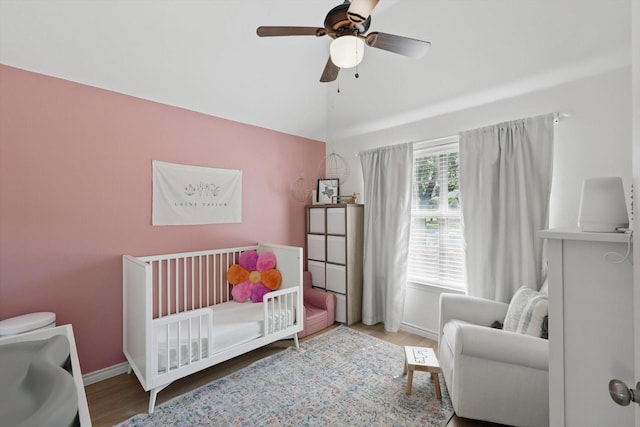 12303 Blue Ridge Dr, Frisco, TX 75033 - bedroom featuring a crib, baseboards, wood finished floors, lofted ceiling, and a ceiling fan