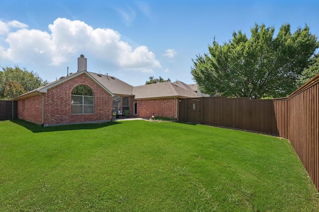 12303 Blue Ridge Dr, Frisco, TX 75033 - back of property with brick siding and a chimney