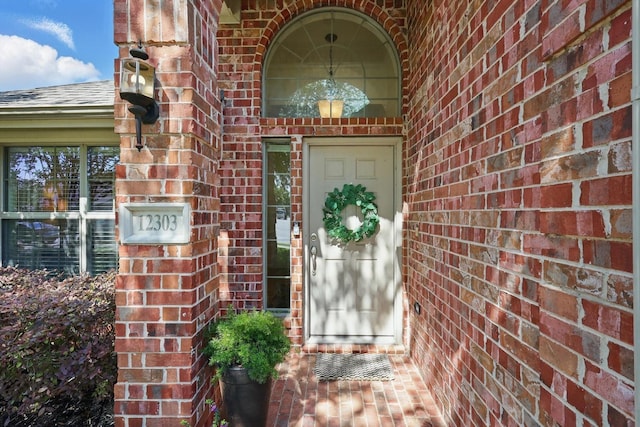 12303 Blue Ridge Dr, Frisco, TX 75033 - view of exterior entry with brick siding and roof with shingles