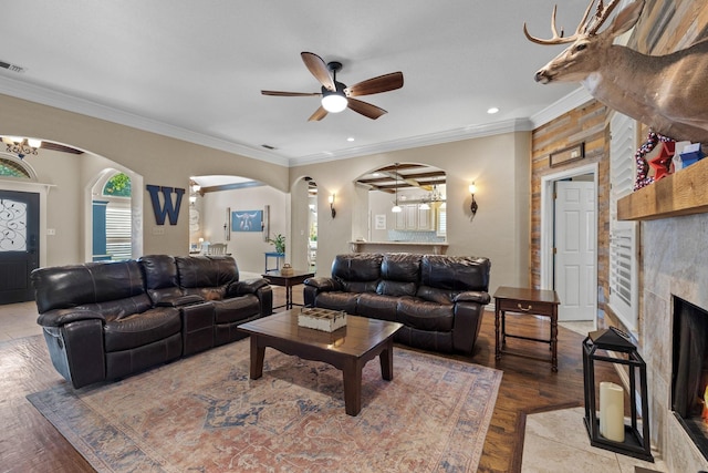 436 Valley View Ct, Aledo, TX 76008 - living room with arched walkways, plenty of natural light, a fireplace, ceiling fan, and crown molding