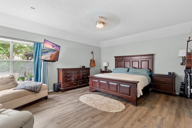 2804 Laurel Hill Dr, Flower Mound, TX 75028 - bedroom featuring wood finished floors, a textured ceiling, a ceiling fan, and baseboards