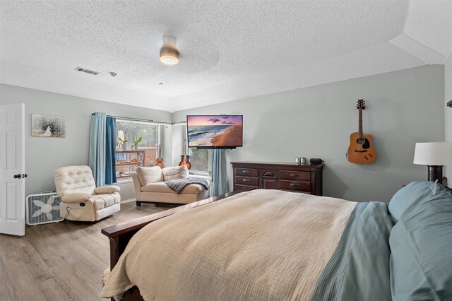 2804 Laurel Hill Dr, Flower Mound, TX 75028 - bedroom featuring wood finished floors and a textured ceiling