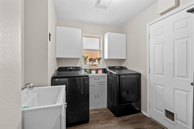 2804 Laurel Hill Dr, Flower Mound, TX 75028 - laundry area featuring cabinet space, separate washer and dryer, a textured ceiling, and dark wood-style flooring