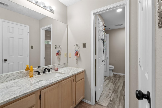 2804 Laurel Hill Dr, Flower Mound, TX 75028 - bathroom with vanity, wood finished floors, toilet, and baseboards