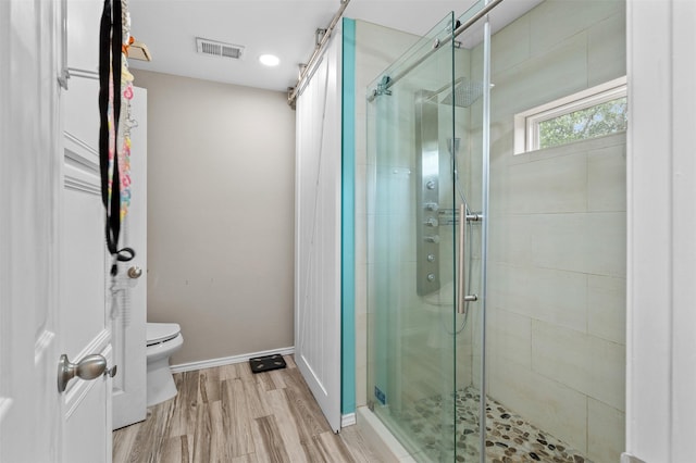2804 Laurel Hill Dr, Flower Mound, TX 75028 - bathroom featuring toilet, a stall shower, wood finished floors, and baseboards