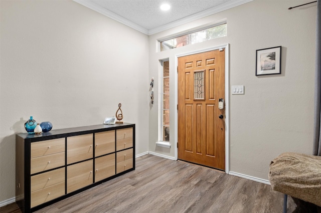 2804 Laurel Hill Dr, Flower Mound, TX 75028 - foyer entrance featuring crown molding, wood finished floors, baseboards, and a textured ceiling