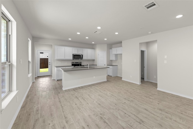 3105 Sedge Grass Dr, Melissa, TX 75454 - kitchen featuring stainless steel appliances, light wood-style floors, healthy amount of natural light, white cabinets, and recessed lighting