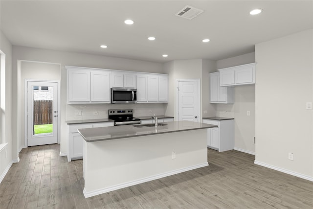 3105 Sedge Grass Dr, Melissa, TX 75454 - kitchen with stainless steel appliances, light wood-type flooring, an island with sink, white cabinets, and recessed lighting