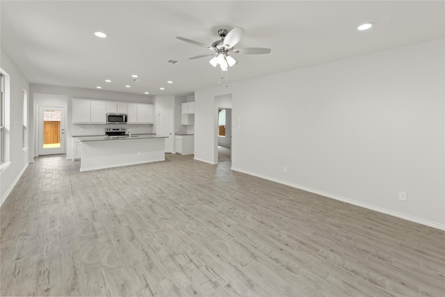 3105 Sedge Grass Dr, Melissa, TX 75454 - unfurnished living room featuring a ceiling fan, light wood finished floors, recessed lighting, and plenty of natural light