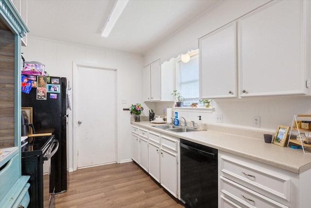 208 Alamosa Dr, Hewitt, TX 76643 - kitchen with black appliances, a sink, light wood-style floors, and white cabinetry
