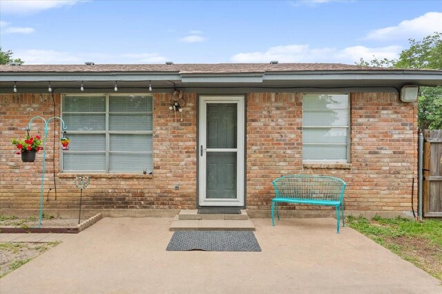 208 Alamosa Dr, Hewitt, TX 76643 - doorway to property featuring a patio and brick siding