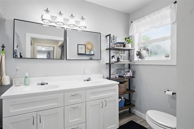 420 Fm 1528, Cooper, TX 75432 - full bath with wood finished floors, double vanity, toilet, and baseboards