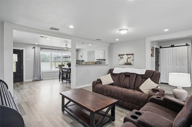 420 Fm 1528, Cooper, TX 75432 - living room with a ceiling fan, recessed lighting, light wood-type flooring, a barn door, and baseboards