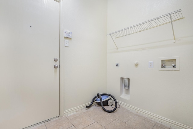 7108 Sugarplum Dr, Plano, TX 75074 - laundry area with hookup for an electric dryer, washer hookup, hookup for a gas dryer, light tile patterned floors, and baseboards