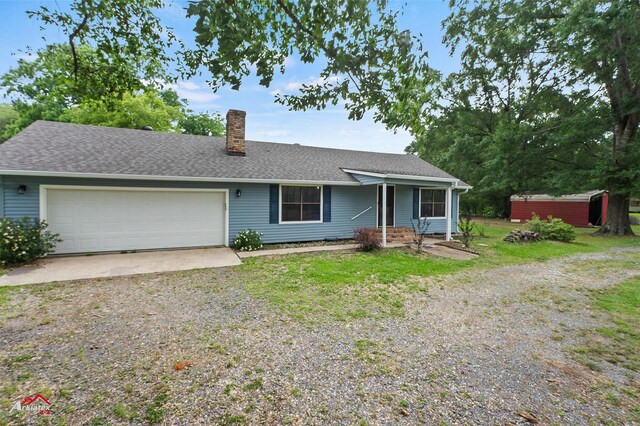 5630 Shreveport Blanchard Hwy, Shreveport, LA 71107 - ranch-style house with driveway, a chimney, a garage, a storage unit, and a shingled roof