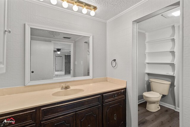 5630 Shreveport Blanchard Hwy, Shreveport, LA 71107 - bathroom featuring a textured ceiling, ornamental molding, wood finished floors, toilet, and vanity