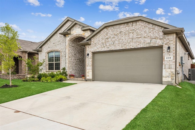 236 Mossy Cliff Ln, Fort Worth, TX 76052 - french country style house featuring an attached garage, driveway, a front lawn, stone siding, and brick siding