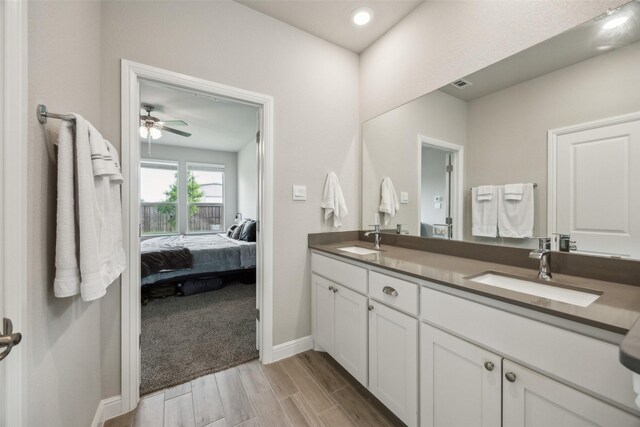 236 Mossy Cliff Ln, Fort Worth, TX 76052 - full bathroom featuring ensuite bathroom, double vanity, wood finished floors, a ceiling fan, and baseboards