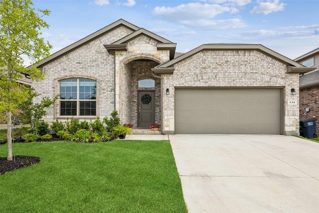 236 Mossy Cliff Ln, Fort Worth, TX 76052 - french country style house featuring an attached garage, a front lawn, brick siding, concrete driveway, and stone siding