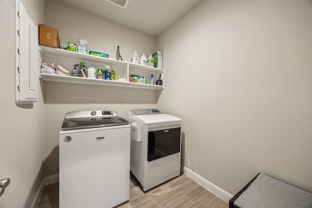 236 Mossy Cliff Ln, Fort Worth, TX 76052 - laundry room featuring washing machine and clothes dryer, wood tiled floors, and baseboards