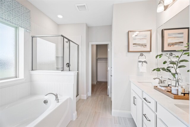 5312 Bordley Dr, Denton, TX 76207 - full bath with a stall shower, a garden tub, double vanity, a walk in closet, and baseboards