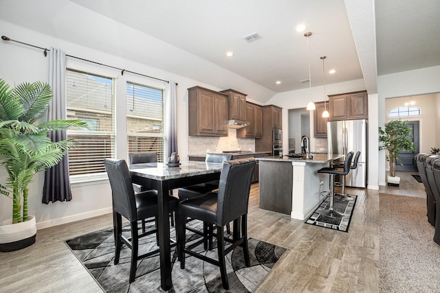 dining area featuring light wood-style flooring, recessed lighting, and baseboards