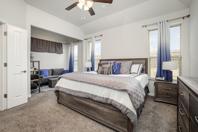 bedroom featuring dark colored carpet, vaulted ceiling, a ceiling fan, and baseboards
