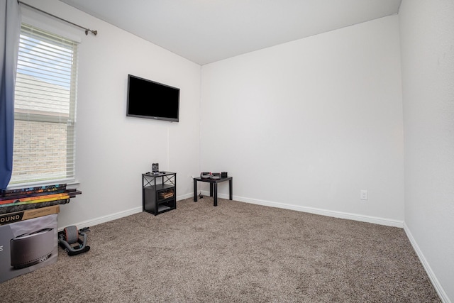 carpeted empty room with baseboards