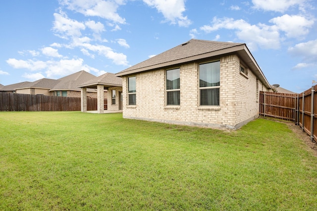 back of property with brick siding and roof with shingles