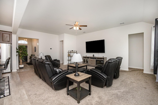 living area featuring a ceiling fan and baseboards