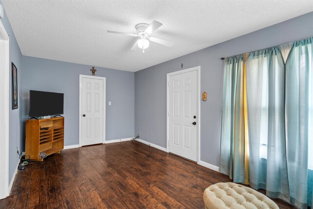 3801 Fort Ave, Waco, TX 76710 - entrance foyer with a ceiling fan, wood finished floors, a textured ceiling, and baseboards