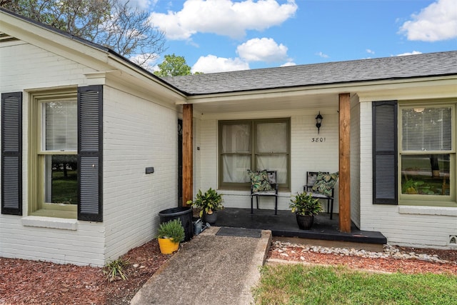 3801 Fort Ave, Waco, TX 76710 - doorway to property featuring a porch, brick siding, and a shingled roof