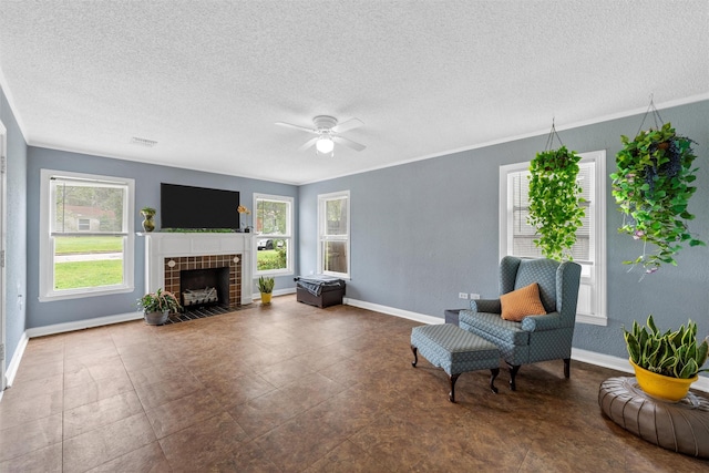 3801 Fort Ave, Waco, TX 76710 - living area with healthy amount of natural light, baseboards, a textured ceiling, ceiling fan, and a tile fireplace